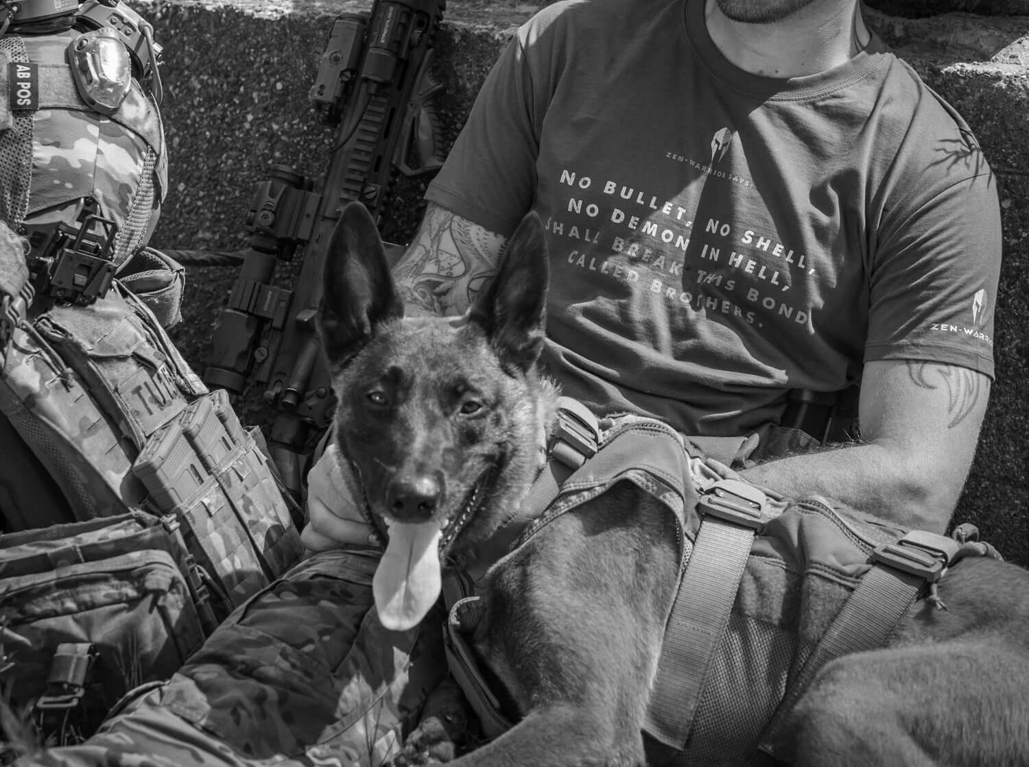 A soldier in tactical gear relaxing with a working dog, showcasing equipment and strong companionship.